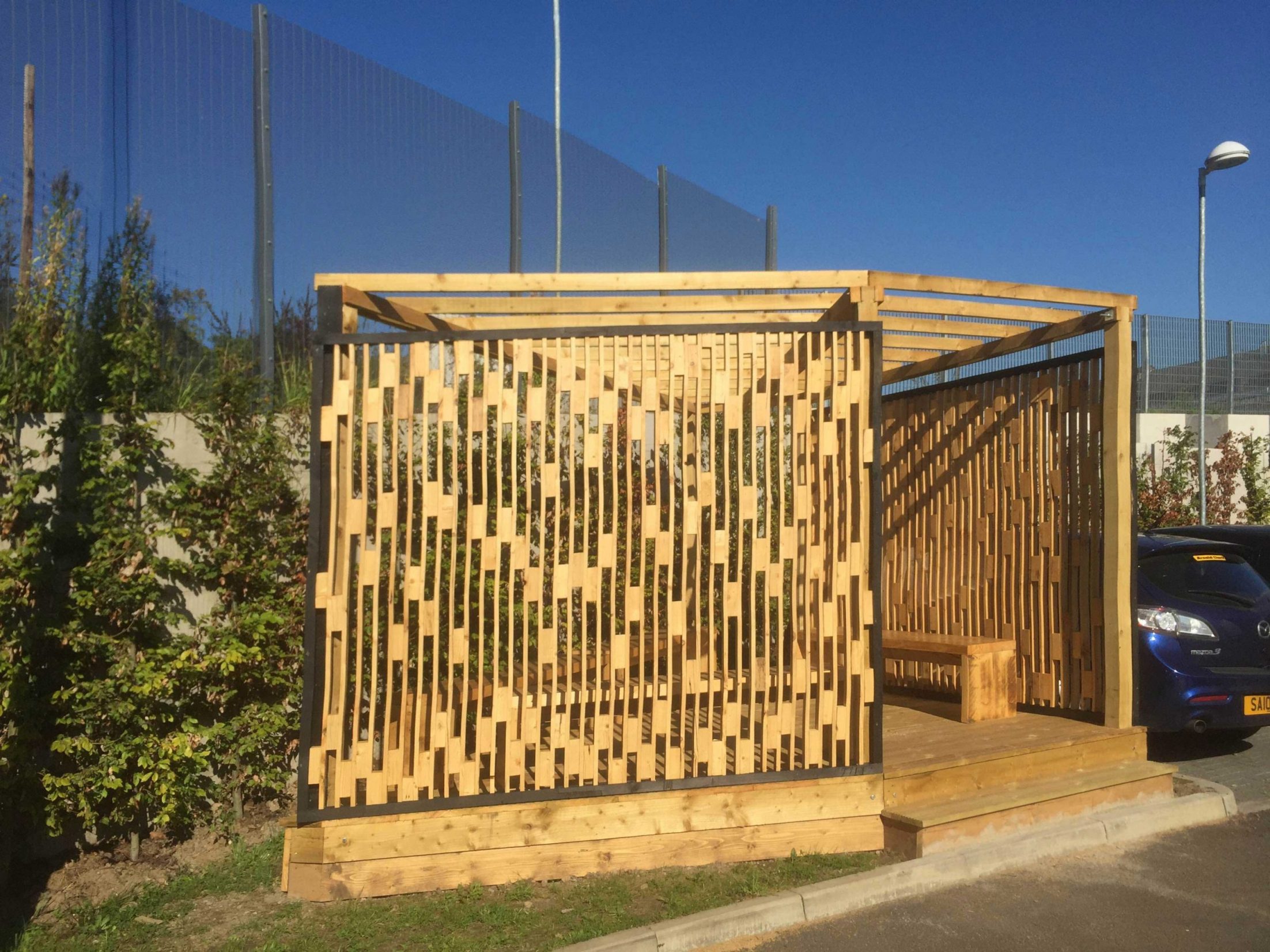 Bespoke pergola with trellis and seating made with reclaimed wood